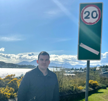 Councillor Stewart with 20mph road sign.
